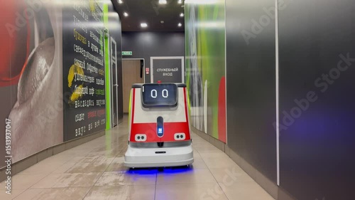 An autonomous cleaning robot moving across the shiny floor of the Vkusno i Tochka restaurant, emphasizing its modern technologies, Vkusno i tochka, Russia, Moscow, 05.05.2025	