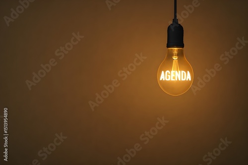 vintage Edison light bulb with AGENDA text glowing against warm background symbolizing business planning concepts