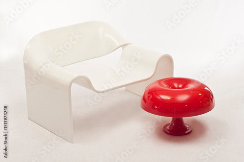 Minimalist white acrylic chair, red lamp
