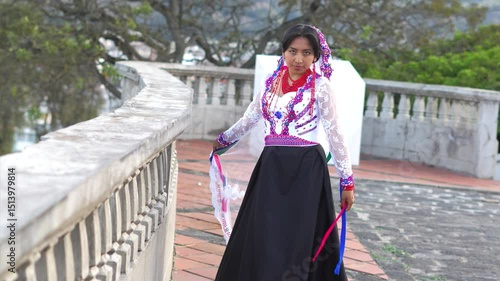 Indigenous woman wearing traditional clothes dancing with veil on terrace