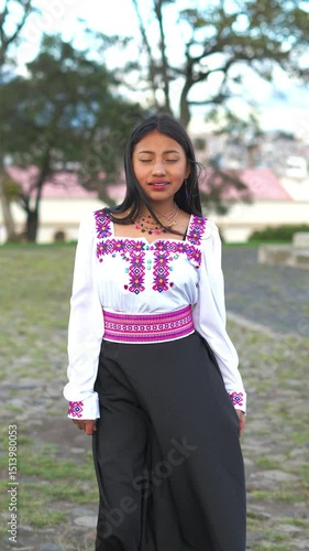 Young otavalo woman wearing traditional clothes posing in park