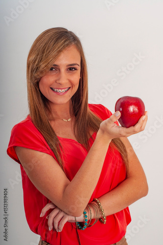 young woman holding red apple