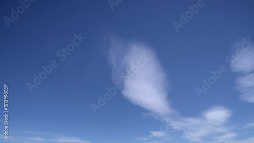 Timelapse of blue sky at daytime with scattered clouds and chemtrails