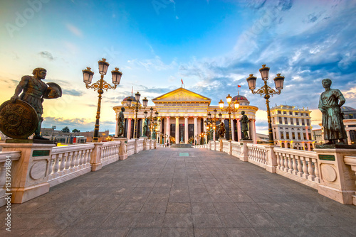 View of the Archaeological Museum of Macedonia in Skopje from the Bridge of Civilizations at sunset with dramatic colors in the sky
