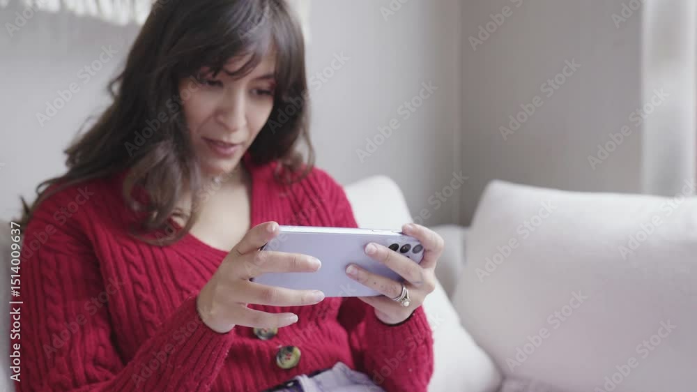A woman engrossed in playing on her smartphone, exuding a blend of focus and joy A woman engrossed in playing on her smartphone, exuding a blend of focus and joy