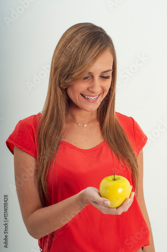 young woman holding an apple