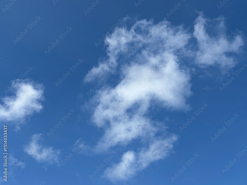 Dynamic composition of pure white clouds, textured against a bright blue sky, unique clouds, weather, bright, suitable for atmospheric backgrounds, or as an eye-catching design element. Dynamic composition of pure white clouds, textured against a bright blue sky, unique clouds, weather, bright, suitable for atmospheric backgrounds, or as an eye-catching design element.