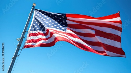 USA flag waiving with blue sky background and flag pole clear day