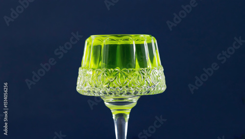 Wallpaper Mural Elegant glass dessert cup filled with vibrant green jelly, showcasing intricate patterns and textures, set against a dark background for a striking visual contrast Torontodigital.ca