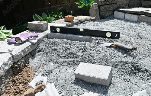 Yard and garden hardscaping pathway and patio project in progress with construction equipment