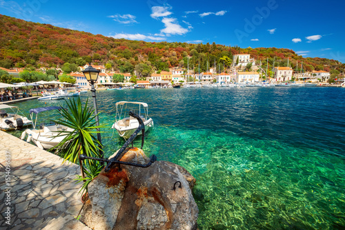 Cozy fishing village of Kioni on the island of Ithaca, with boats moored in the Ionian Sea near Kefalonia