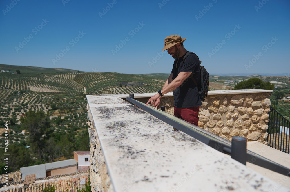 Man Exploring Historical City with Scenic Mountain Vineyard View Man Exploring Historical City with Scenic Mountain Vineyard View