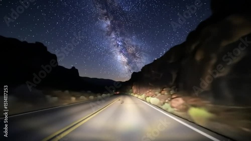 Night Journey: Under the mesmerizing night sky, a winding road beckons travelers towards the unknown, flanked by majestic rock formations that stand as silent guardians of the starlit path.