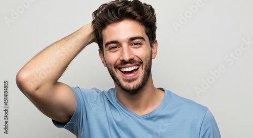 Joyful Portrait of Laughing Young Man Indoors with Curly Hair
