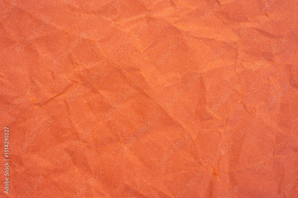 Fototapeta premium Full frame shot of crumpled orange colour paper sheet texture and background.