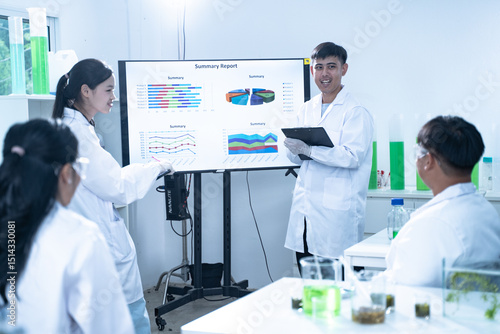 In the laboratory, a group of researchers meets to report their findings, discussing their work and preparing for future experiments, all focused on advancing science and health care.