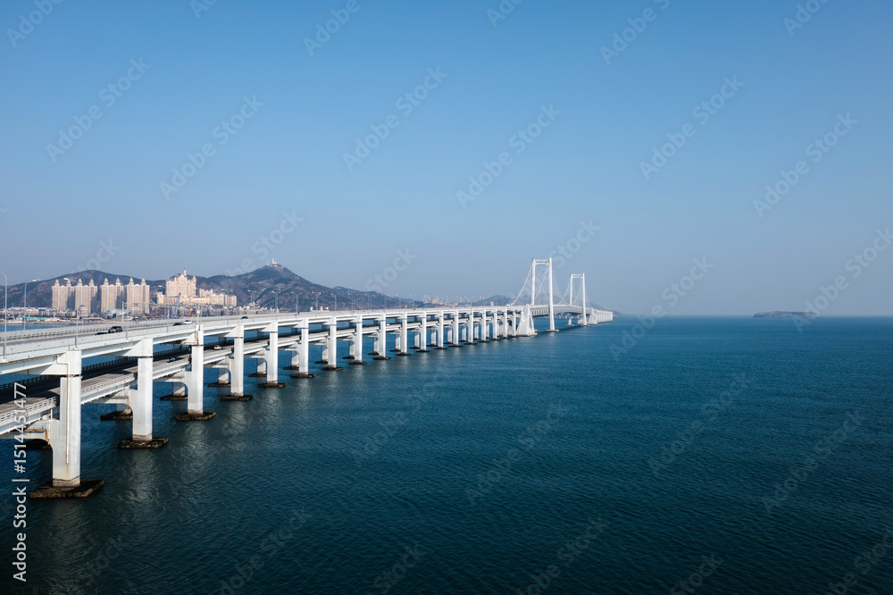 Obraz premium Aerial photography of Dalian Cross-sea Bridge and Xinghai Bay Bridge, taken in Dalian, Liaoning Province, China 