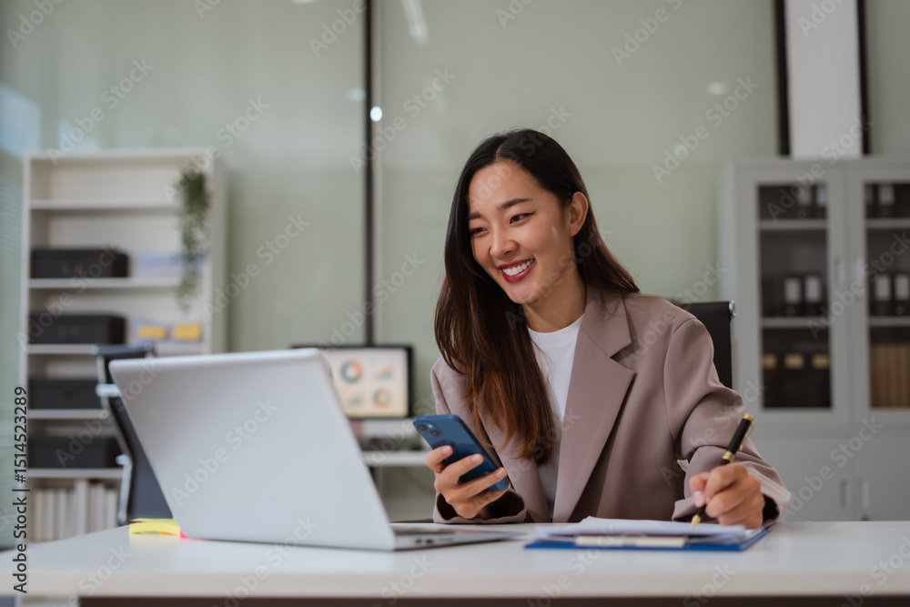 Businesswoman hand working at a tablet, computer and writing on a notepad with a pen in the office. on the wooden desk there a graph business diagram. Businesswoman hand working at a tablet, computer and writing on a notepad with a pen in the office. on the wooden desk there a graph business diagram.