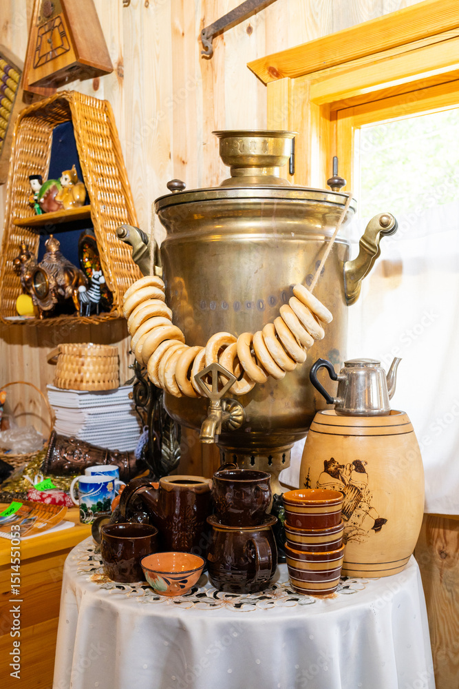 Fototapeta premium Russian samovar with steering wheels in an old Russian hut