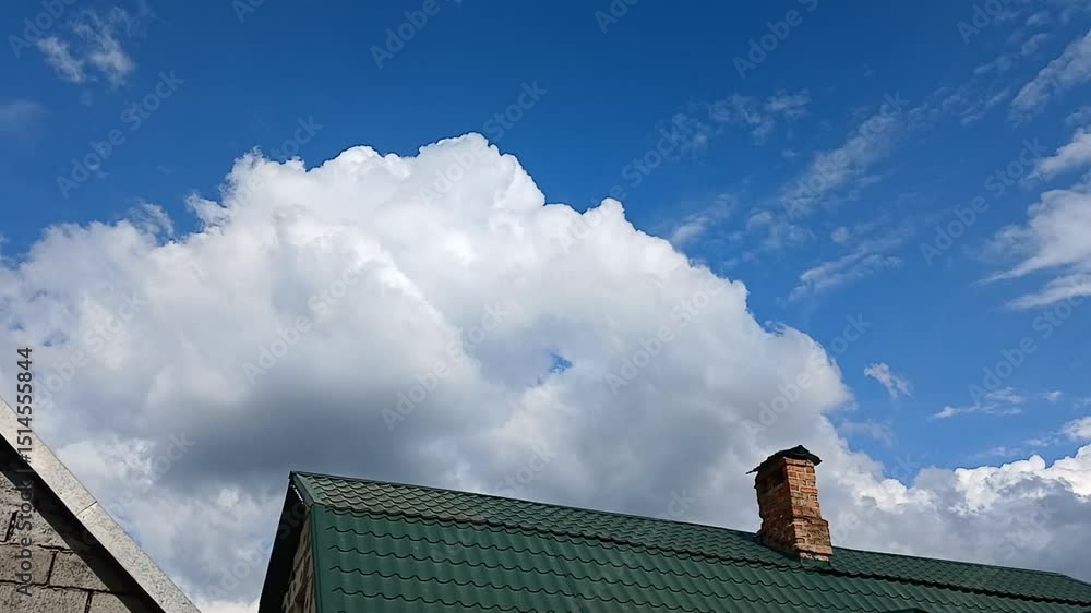 Big white cloud over the green roof of a house, horizontal video Big white cloud over the green roof of a house, horizontal video