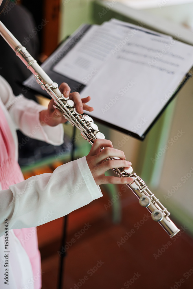 Fototapeta premium Young Musician Playing Flute at Practice Session