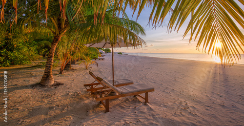 Fototapeta Naklejka Na Ścianę i Meble -  Closeup sunset sky sea sand beach chairs umbrella and palm leaves. Dreamy tropical vacation travel. Luxury seaside escape, romantic coastal view. Summer relaxation best exotic travel paradise getaways