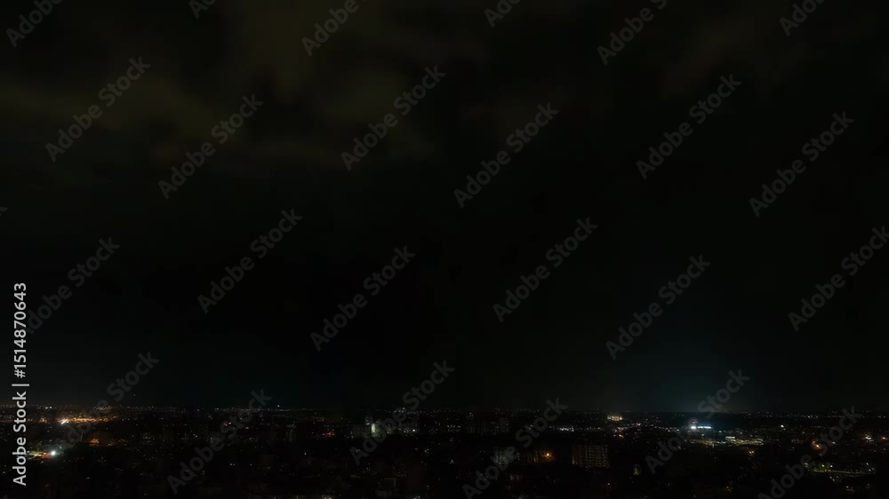 City skyline at night with illuminated lights and cloudy sky City skyline at night with illuminated lights and cloudy sky