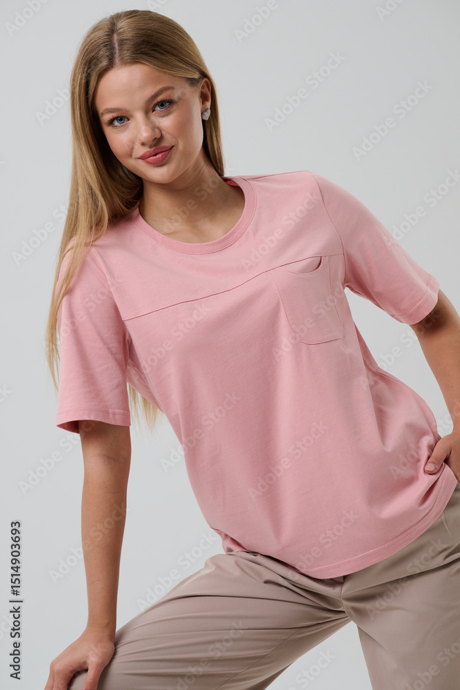 Fototapeta premium Girl model in casual clothes on a gray background posing in the studio