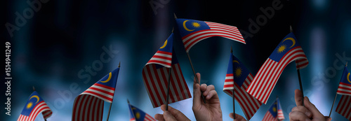 Photography Malaysia flags in their hands on a blurred urban background