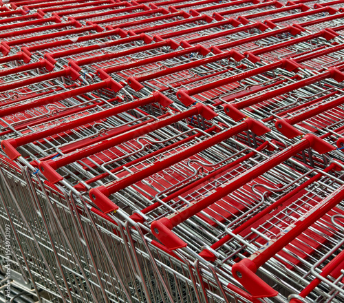 фотографія A row of shopping carts is neatly lined up in a straight row