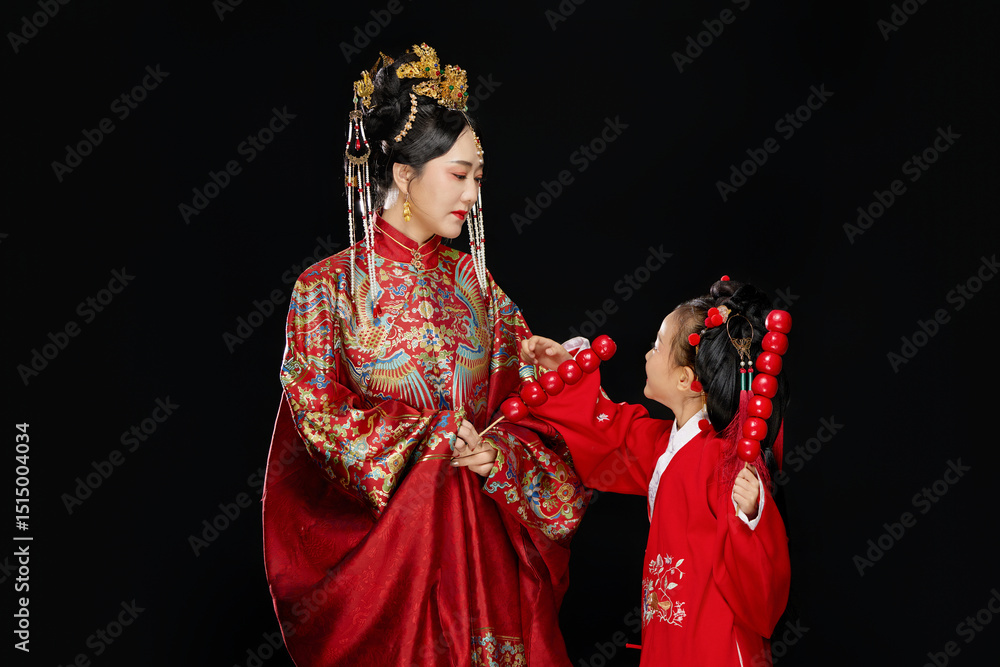 Φωτογραφία Portrait of Chinese mother and daughter dressed in Hanfu costumes on black backg