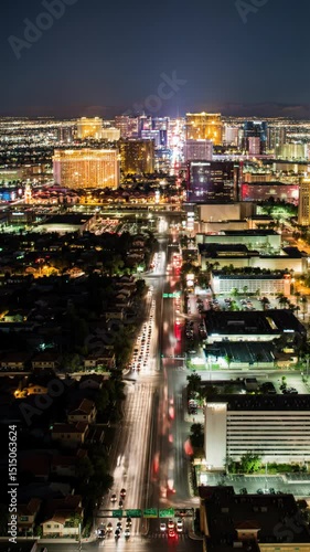time-lapse video of Las Vegas city skyline from high angle, wide elevated viewpoint. dusk to night, residential lights twinkle, distant strip and downtown illuminate. traffic flows creating dynamic