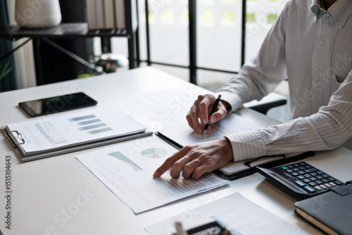 Canvastavla Administrative staff reviewing company budget report with calculator, document s