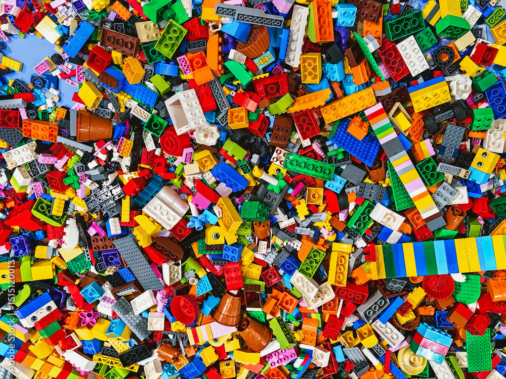 Naklejka premium NAKHON PATHOM,THAILAND - JANUARY 17 ,2025 : Top view A pile of multicolor of many Lego toy blocks in various shapes and different sizes at Central salaya. Toys and games. Leisure and recreation.