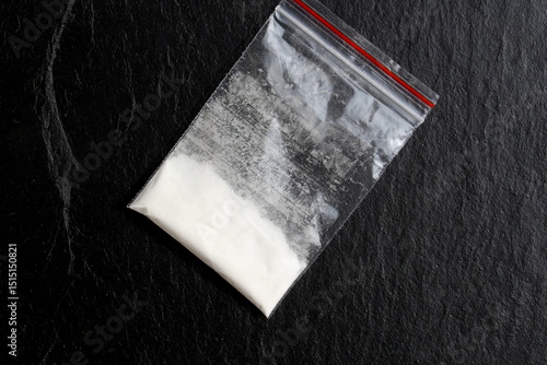 There is a bag of drugs on a black background.