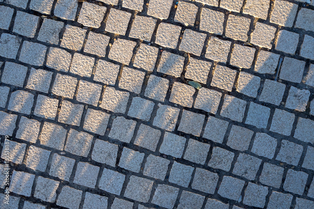Natural stone paving with green moss in joints. Illustrates eco-friendly urban landscaping. Diagonal arrangement. Architectural background. Natural stone paving with green moss in joints. Illustrates eco-friendly urban landscaping. Diagonal arrangement. Architectural background.