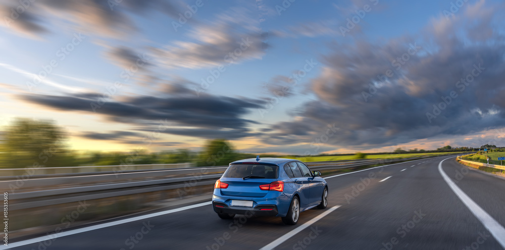 Red car on highway. Sunset drive. Motion on road Red car on highway. Sunset drive. Motion on road