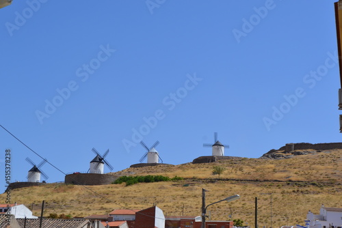 Historic windmills on a hill in spain under clear blue skies. Consuegra. La Mancha. Spain