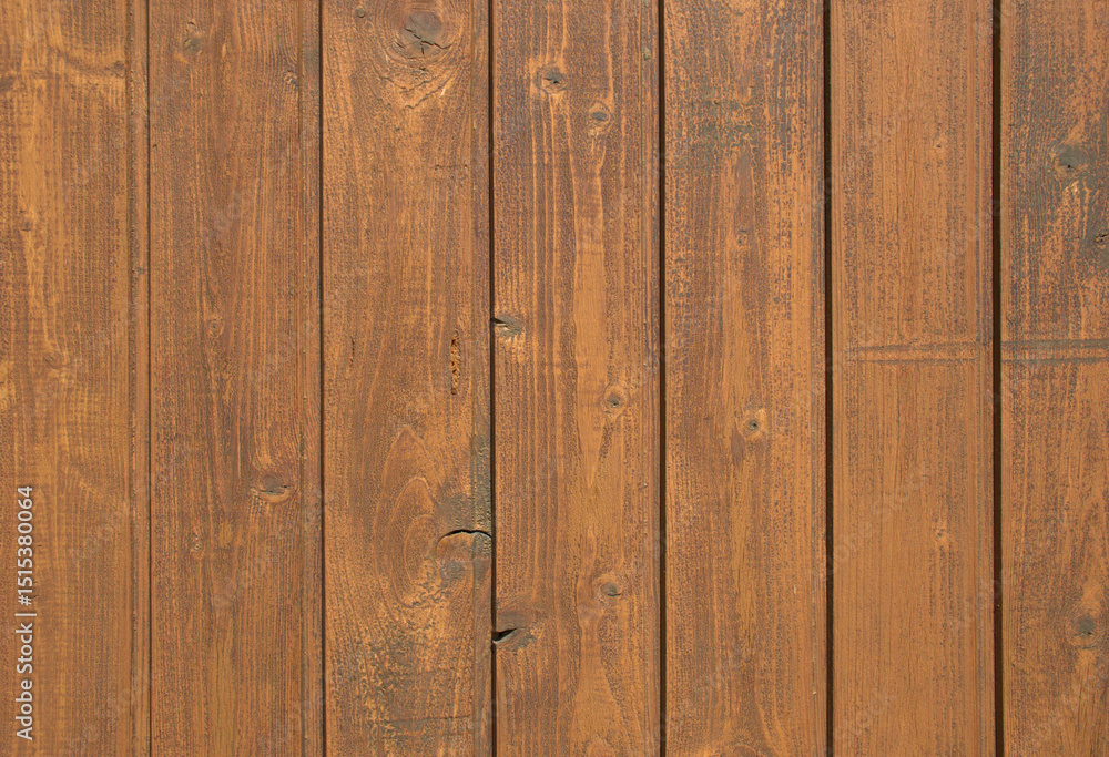 Fototapeta premium Close-up full-frame vertical wooden planks, rich brown finish and visible natural wood grain. Rustic texture and organic pattern, wallpaper background. Carpentry, architecture countryside visuals. 