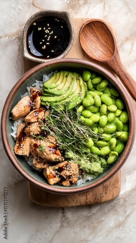 Healthy Bowl With Grilled Chicken, Avocado, and Edamame Served in a Rustic Di...