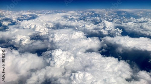View from airplane window to the sky and clouds from above.