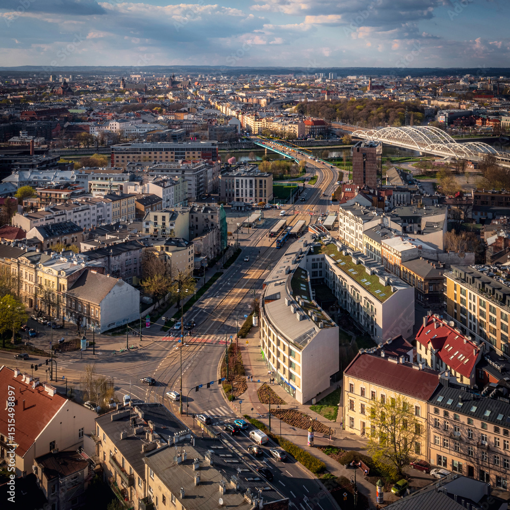 Fototapeta premium Main road in Podgorze district in Krakow, Poland during sunset at golden hour. Soft light, afternoon.