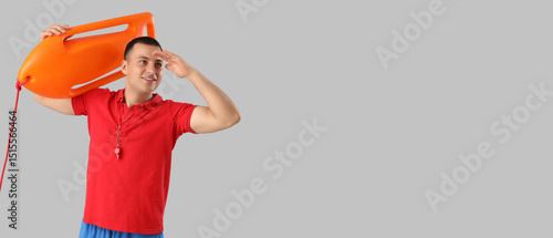 Happy male lifeguard with l...