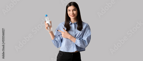 Young Asian woman pointing ...