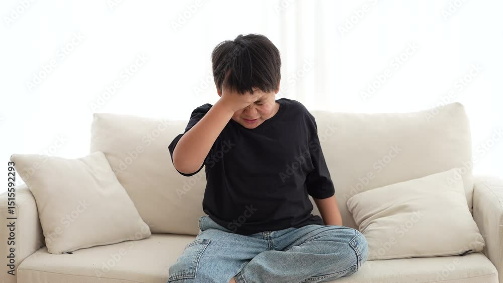 Portrait of sick depressed unhappy child boy touching on head feel suffering head ache pain flu high fever, alzheimer, cancer, stroke, parkinson, disease, cerebral haemorrage, encephalitis, dementia Portrait of sick depressed unhappy child boy touching on head feel suffering head ache pain flu high fever, alzheimer, cancer, stroke, parkinson, disease, cerebral haemorrage, encephalitis, dementia