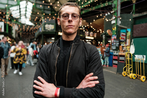 Wall Mural Security guard standing with crossed arms in borough market, london