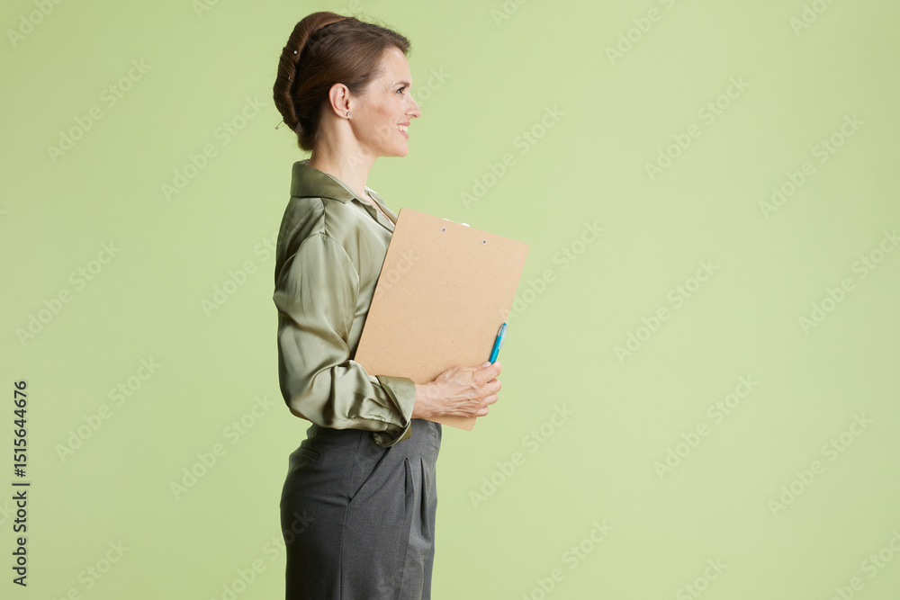 Professional woman in profile with clipboard Professional woman in profile with clipboard
