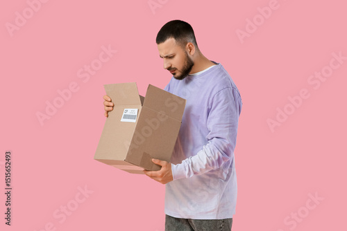Upset young man unpacking p...