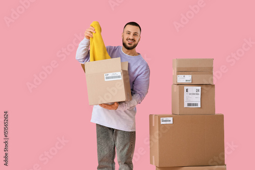 Young man with parcels taki...