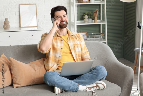 Handsome man with laptop ta...